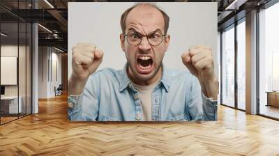 man wearing glasses blue jeans jacket anggry yelling open mouth white background Wall mural