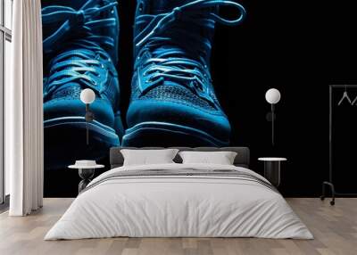 Close up view of levitation blue sneakers shoes with flying laces over black background with copy space for text.  Wall mural