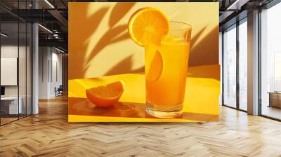 Fresh half slice of ripe orange fruit floation with splash drop on orange juice with copy space.  Wall mural