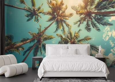 Looking up at blue sky and palm trees, view from below, vintage style, tropical beach and summer background, travel concept.  Wall mural