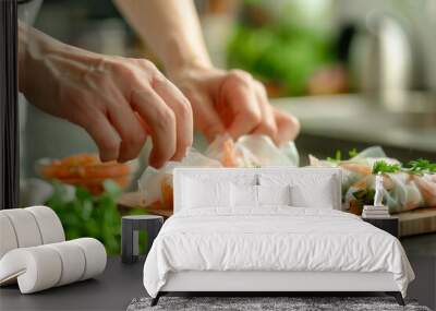 A closeup of hands preparing spring rolls with fresh vegetables and shrimp inside rice paper on a wooden board in the kitchen. The background is blurred to focus attention on the hand movements. Wall mural