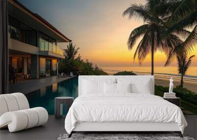 A modern villa with an infinity pool and garden, offering a view of the ocean at sunset. Wall mural