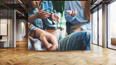 A group of young people sitting and talking together Wall mural