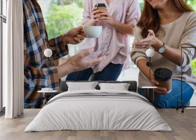 Closeup image of a group of young people enjoyed talking and drinking coffee together Wall mural