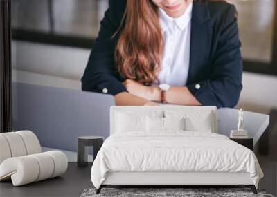 closeup image of businesswoman pointing finger at paperwork while working on laptop in office Wall mural