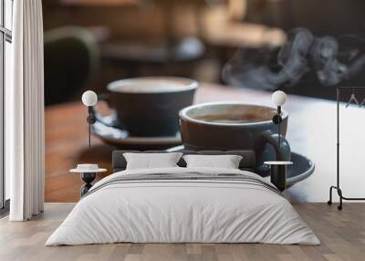 Closeup image of two blue cups of hot  coffee on vintage wooden table in cafe Wall mural