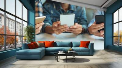 Group of young people using and looking at mobile phone while sitting together Wall mural