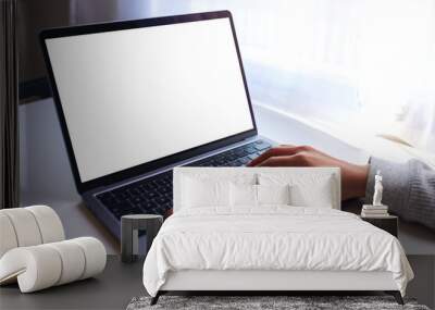 Mockup image of a businesswoman using and typing on laptop computer keyboard with blank white desktop screen on the table Wall mural