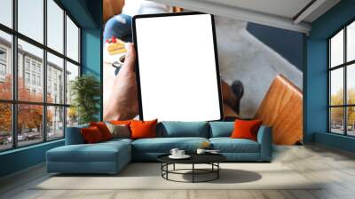 Mockup image of a man holding digital tablet with blank white desktop screen in cafe Wall mural