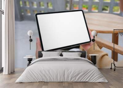 Mockup image of a woman holding digital tablet with blank white desktop screen Wall mural