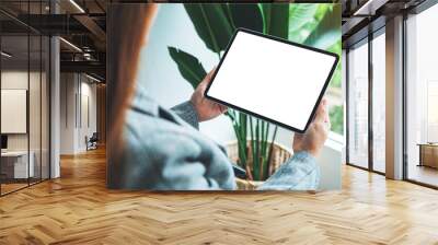 Mockup image of a woman holding digital tablet with blank white desktop screen Wall mural