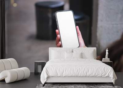 Mockup image of a woman holding mobile phone with blank desktop screen Wall mural