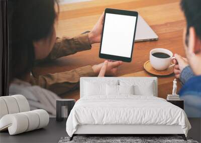 People using, looking and pointing at the same mockup tablet pc on wooden table together Wall mural