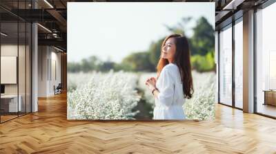 Portrait image of an asian woman in a beautiful Cutter flower field Wall mural