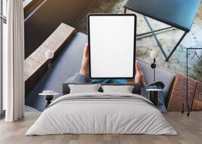 Top view mockup image of a woman holding black tablet pc with blank white desktop screen Wall mural