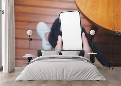 Top view mockup image of a woman using and holding mobile phone with blank screen Wall mural