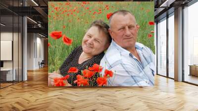 lovely senior couple enjoying in the poppy field Wall mural