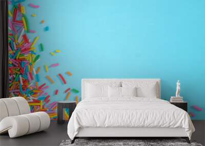 Border frame of colorful sprinkles on blue background Wall mural