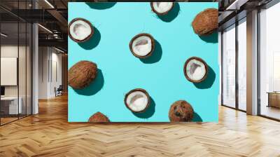 Creative layout of coconuts half on blue background. Tropical pattern, top view or flat lay. Hard light pop art minimal summer background. Horizontal banner Wall mural