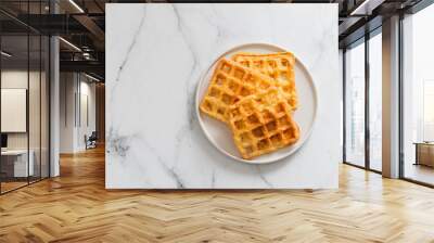 Delicious savory keto waffles. Two ingredients chaffles on plate over white marble background. Eggs and parmesan cheese low carb waffles. Top view or flat lay. Copy space left for text or design. Wall mural