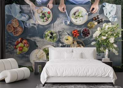 family dinner outdoors. family dinner with organic salad and cheese on trendy scandinavian style tab Wall mural