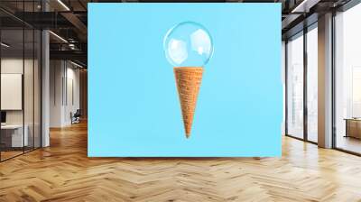 Ice cream cone with soap bubble on blue background Wall mural