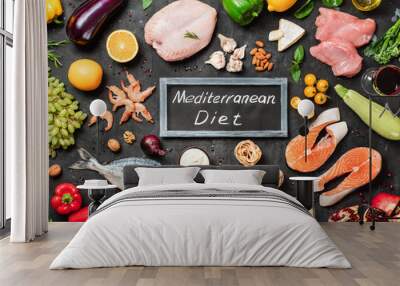 Mediterranean diet concept. Top view of food ingredients and chalkboard with words Mediterranean Diet in center. Dark background. Flat lay. Wall mural