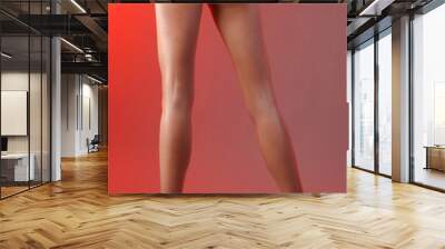 Sexy smooth female legs on a red background Wall mural