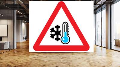 Low temperature warning sign. Vector illustration of red triangle sign with snowflake and blue thermometer icon inside. Winter concept. Very cold and freezing. Caution symbol isolated on background. Wall mural