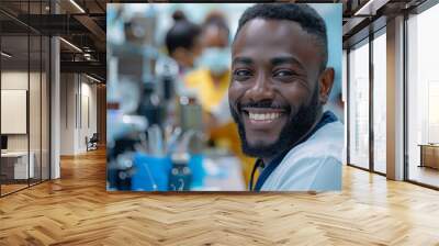 Close-up portrait of a male dentist posing at dental clinic with modern advanced equipment. Young African American clinician wearing white medical uniform with confident smile. Wall mural