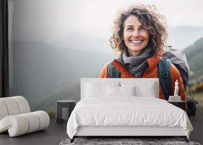 Happy middle age woman hiking on the top of mountain Wall mural