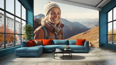 Happy middle age woman hiking on the top of mountain Wall mural