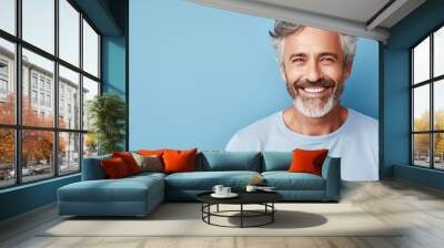 Happy smiling middle aged adult man on a solid background Wall mural