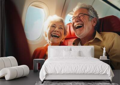 Senior couple on an airplane ready for vacation Wall mural