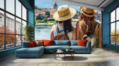 Two young women are enjoying a trip to a European village Wall mural