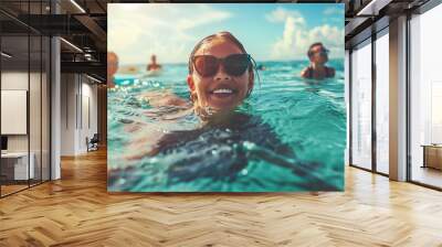 Young adults enjoying a swim together in the ocean Wall mural