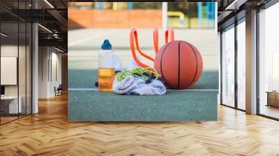 Sports equipment for sufficient quality training and fun. Sports outdoor playground. Game lifestyle. Towel, basketball, jump rope, t-shirt, towel and drink. Essential equipment for every athlete Wall mural