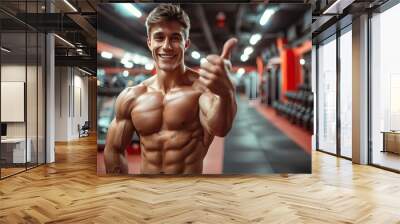 Man gives thumbs up at gym for workout Wall mural