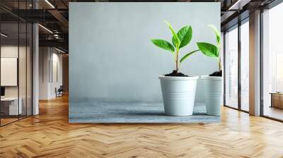 Two small green plants in pots. Wall mural