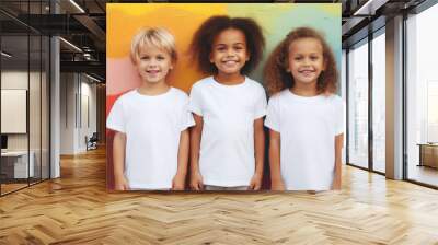 Little children wearing white t-shirts standing in front of colorful background together, blank apparel with no print, smiling toddlers, photo for  mock-up Wall mural