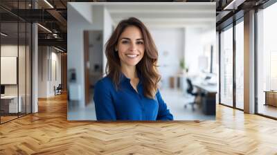 Portrait of hispanic middle aged businesswoman with arms crossed and blue shirt standing in her office. Executive at work.  Wall mural