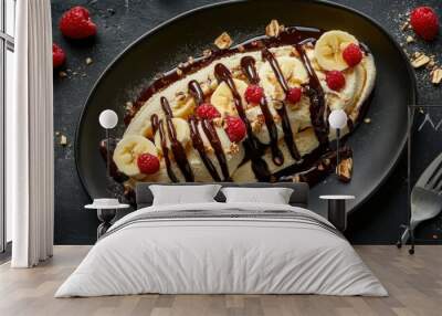 Decadent banana split dessert including colorful toppings creatively organized, showing chocolate syrup, banana slices, and ice cream; expertly shot from above using food photography. Wall mural