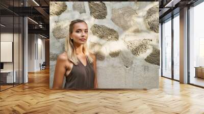 Woman with Natural Texture-  A minimalist portrait of a woman against a natural, textured wall with copy space, for beauty, fashion, or architectural design projects Wall mural