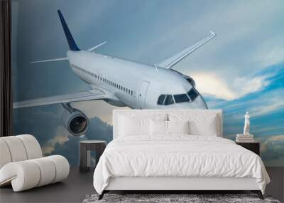 Airplane in sky. White passenger jet fly among clouds. Travel by air transport Wall mural