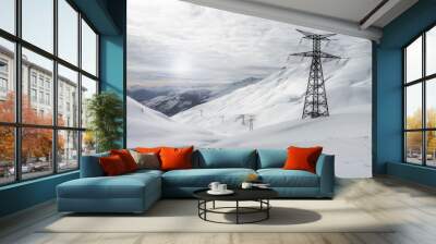 white winter landscape in snowy mountains, high voltage towers Wall mural