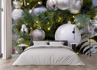 White and silver Christmas balls and garlands on Christmas tree Wall mural