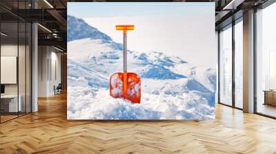 Shovel for  snow cleaning during snowfall or avalanche. Snow storm in winter time season. Tool for maintenance during drive away. Wall mural