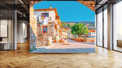 View on old medieval Greek city Nafpfktos Though arch in ancient medieval castle wall, popular and famous travel landmark. Nafpaktos is popular European travel destination. Old houses on embankment.  Wall mural