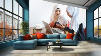 new generation businesswoman muslim people meeting in coffee shop with computer and coffee cup on wood desk Wall mural