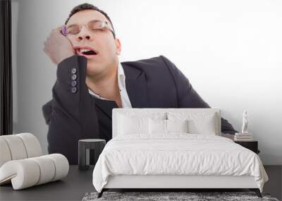 exhausted businessman sleeping at his desk yawning Wall mural